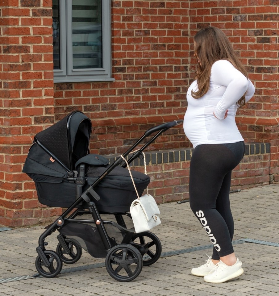 She wore a white top and leggings as she pushed the buggy through Essex