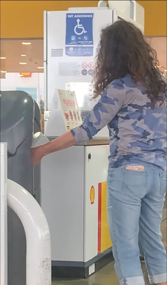 The woman emptied out water bottles at the Shell garage in Cobham Services to fill up