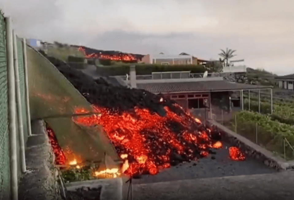 The moment a river of lava swept into the garden of a house