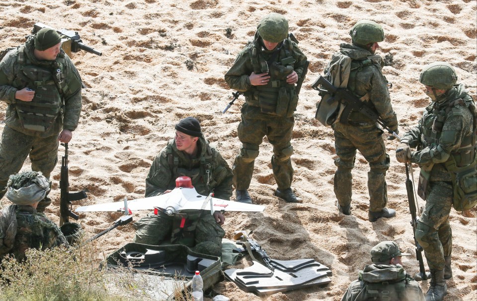 Russian soldiers handle a drone