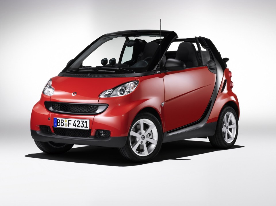 A convertible Smart car takes pride of place in Coulthard's garage