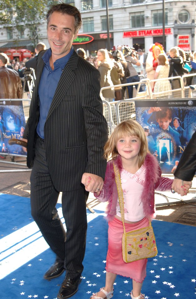 Gaia Wise holds her dad Greg's hand at the Nanny MacPhee film premiere in 2005