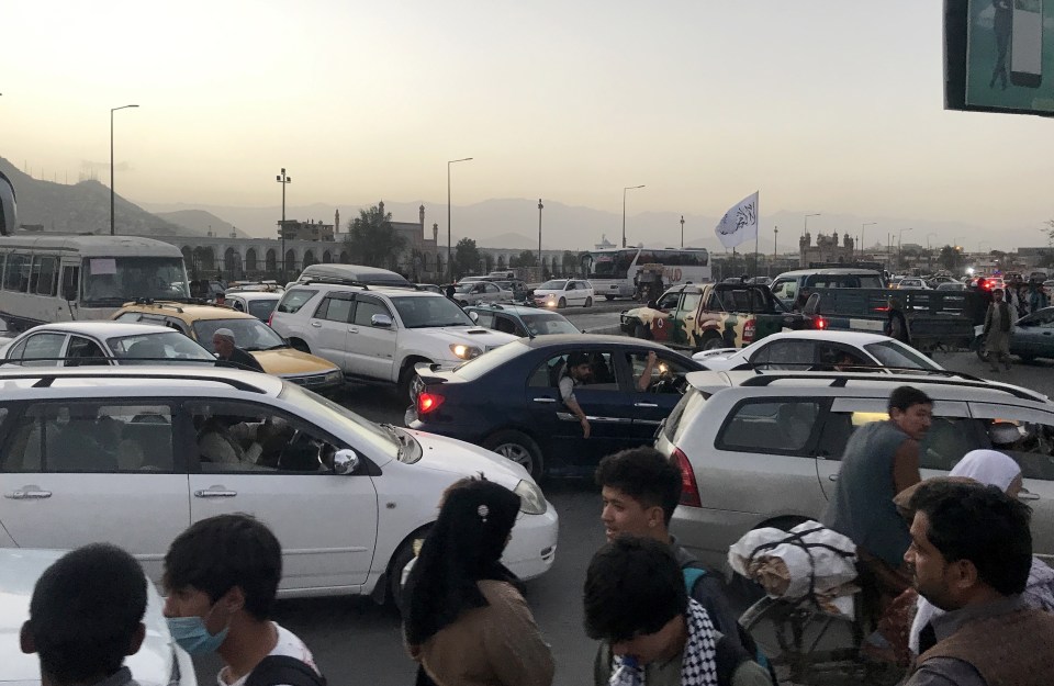 Cars seen in a street after an explosion near the Eid Gah Mosque