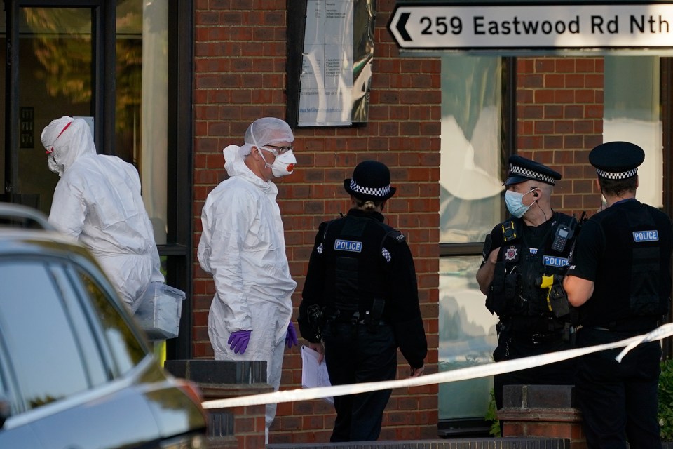 Police officers talk at the scene where British Conservative lawmaker David Amess died