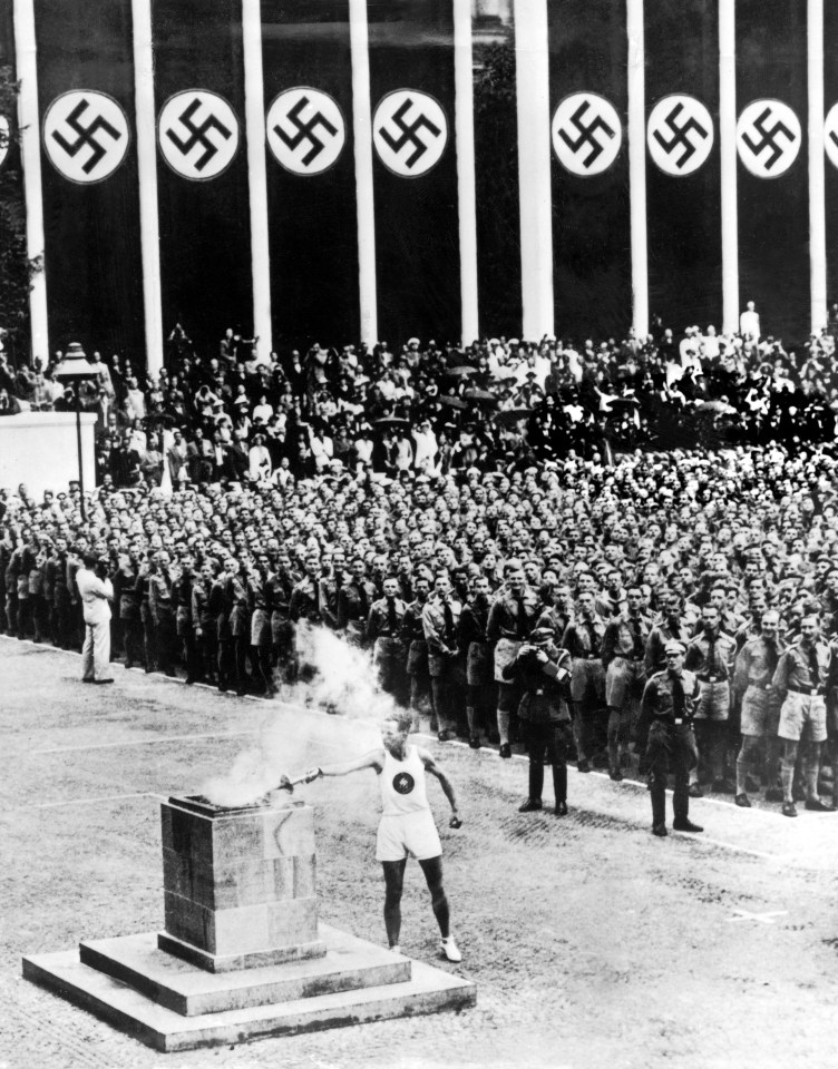 The Berlin Olympics in 1936 saw the torch lite with a backdrop of swastikas