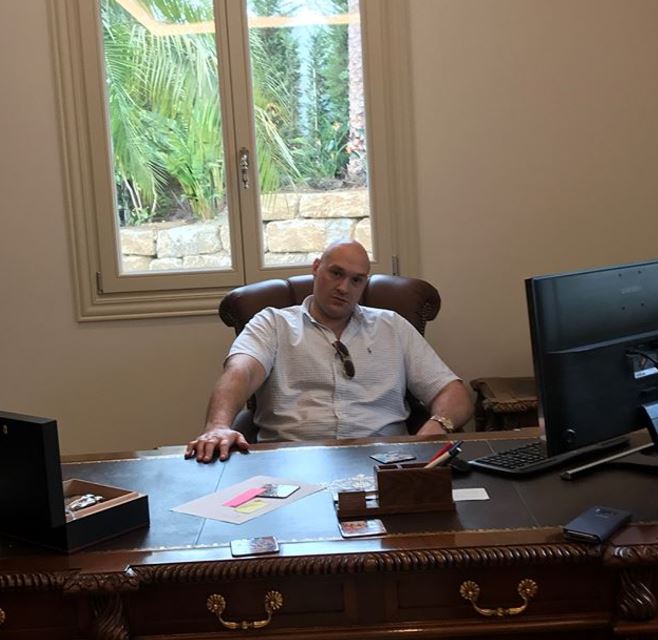 Tyson pictured sitting in front of a desk believed to be in one of his homes abroad