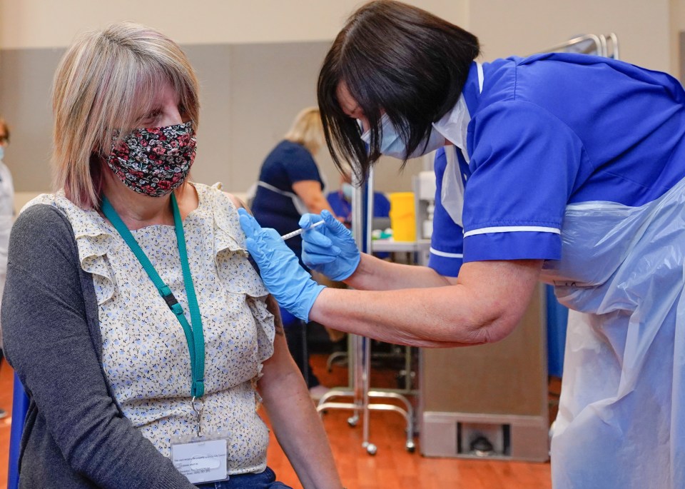 There are concerns the booster campaign is too slow. Pictured: Social worker Melody Howard receives her third shot at Midland House in Derby