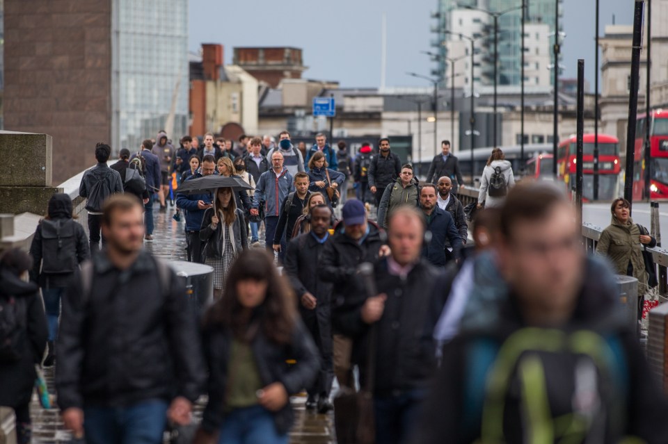 Commuters cross London Bridge this morning