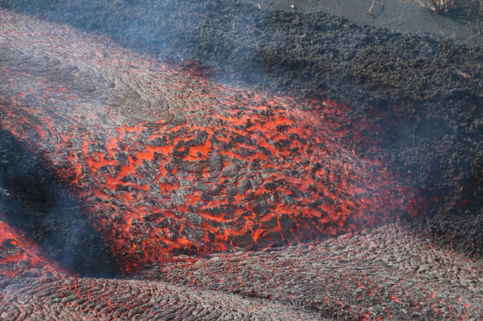 Molten lava carving a path in the earth