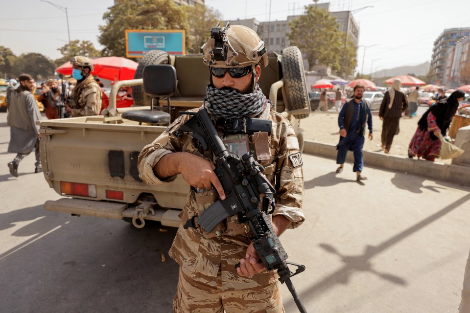 A member of Taliban forces stands guard on a street in Kabul