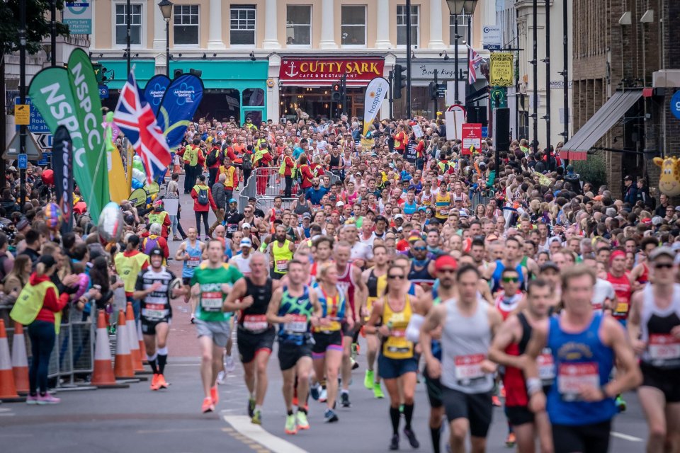 Runners are seen cheering on the Covid-safe crowds