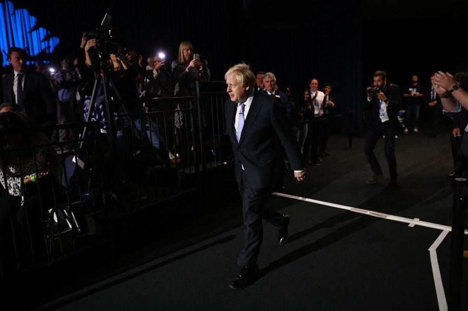 The PM walks into a packed conference hall for his keynote address