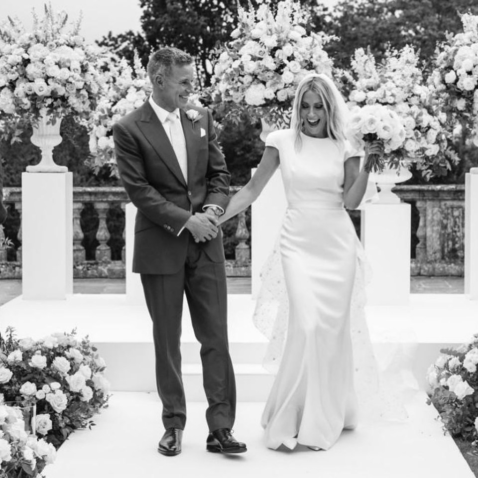 The pop star looks stunning in a white gown surrounded by flowers