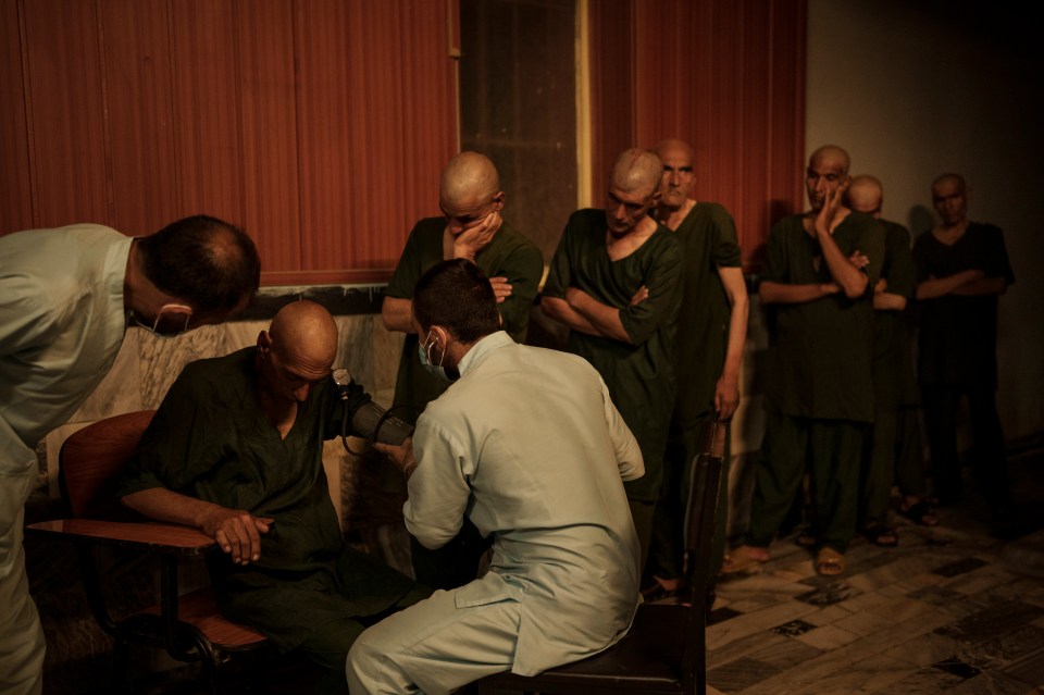 The men queue as they wait to be seen by doctors