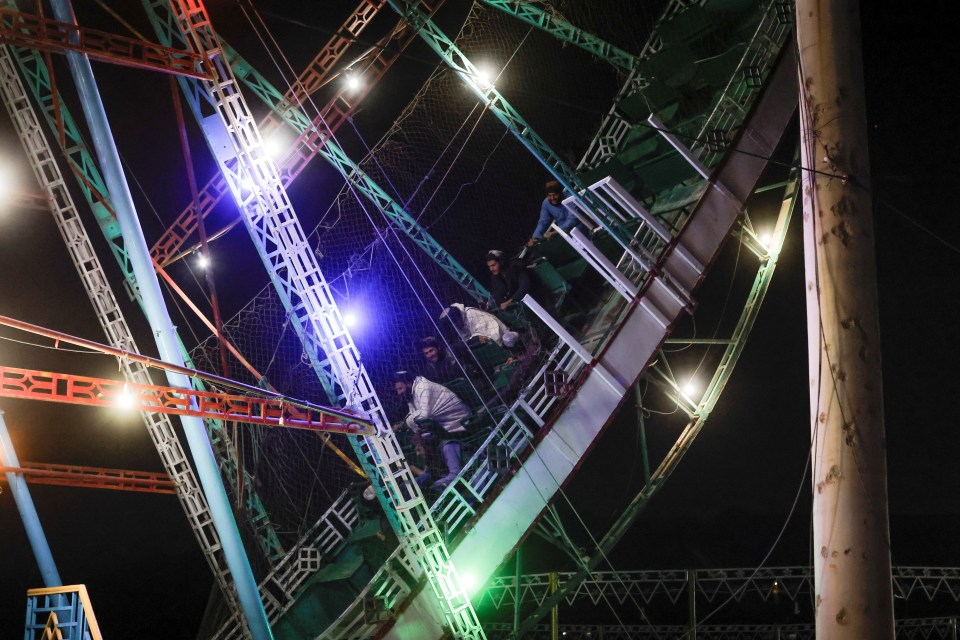 The militants ride a swinging pirate ship at the park in Kabul