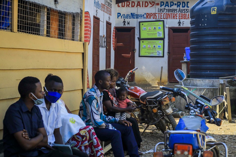 Patients wait outside Butsili health centre on Saturday, just three days after the three-year-old died of Ebola there