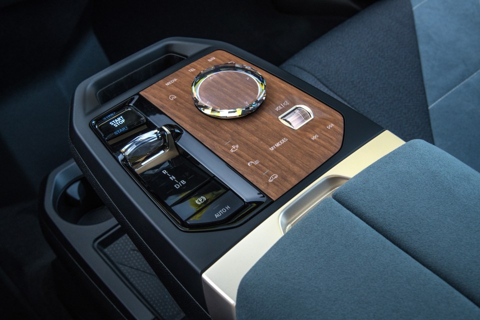 Glass switches and gold-bronze brushed metal highlights give the iX a boutique feel