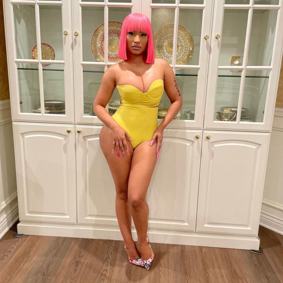 Nicki Minaj's clothing choices are about as ridiculous as her opinions, here she posed in this bright yellow swimming costume and pink wig