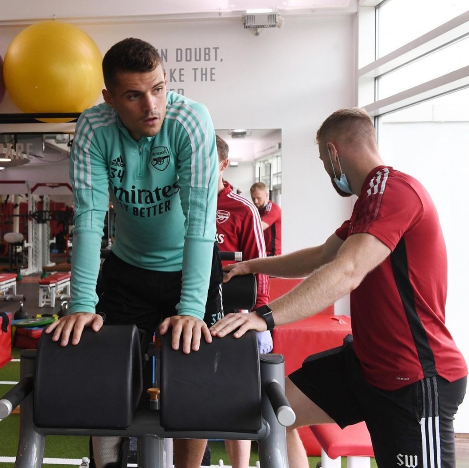 An Arsenal physio monitoring Xhaka's progress