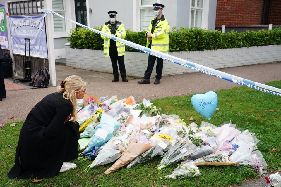 Another knelt at the cordon to read messages left by mourners