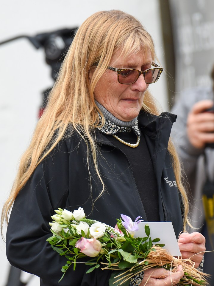 One woman was seen in tears as she delivered a bouquet