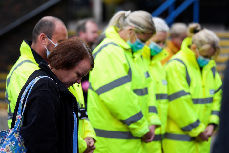 Mourners bowed their heads during the vigil this evening