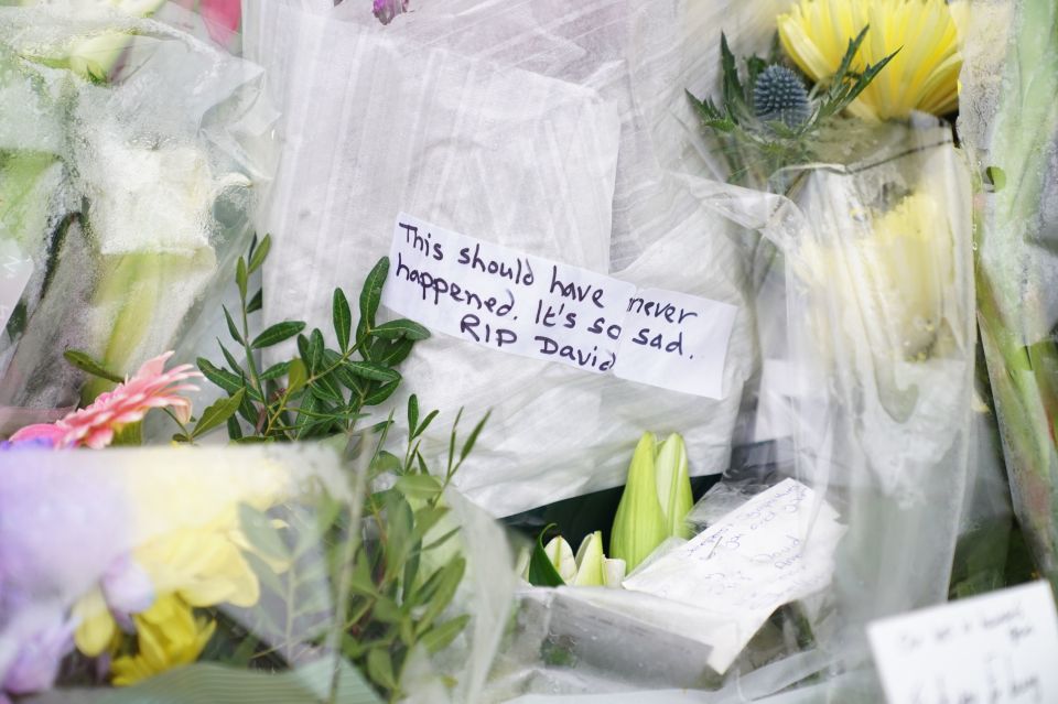 A tribute on a card from a wellwished was laid next to flowers