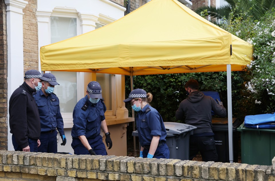 Officers look for evidence in the front garden