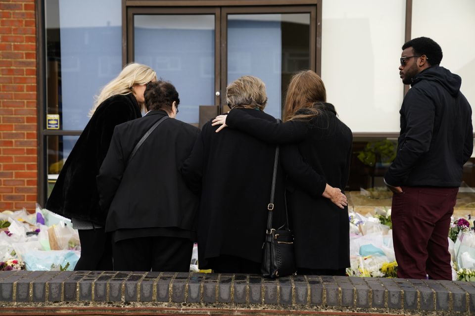 Sir David's family embrace as they read tributes to the MP