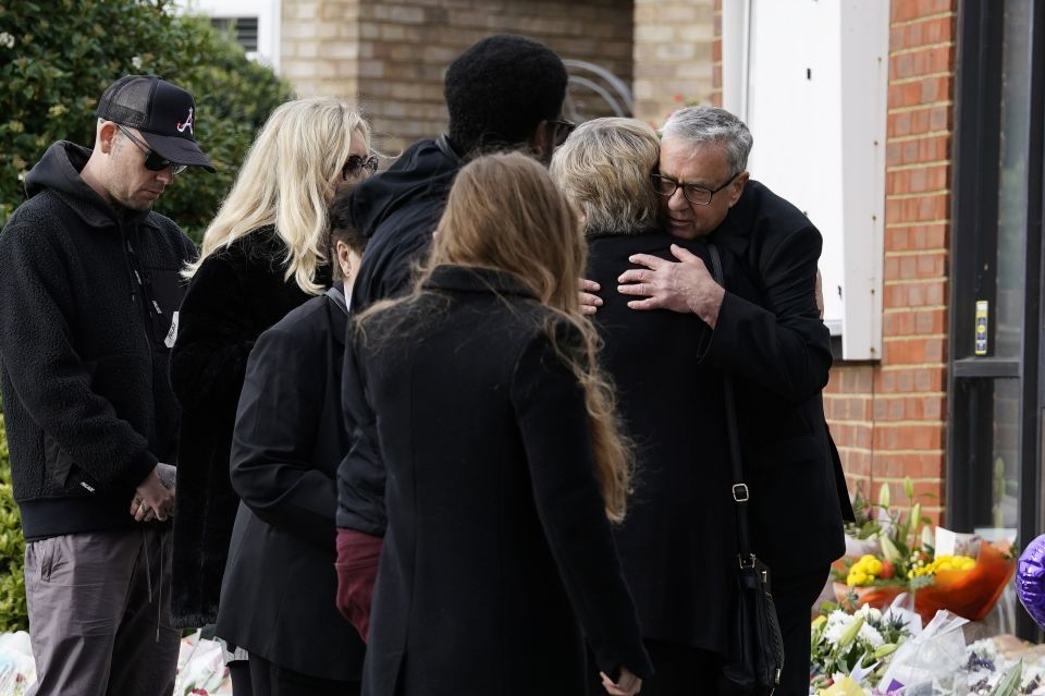 The minister of Belfairs Methodist Church, Rev Clifford Newman, hugs the widow