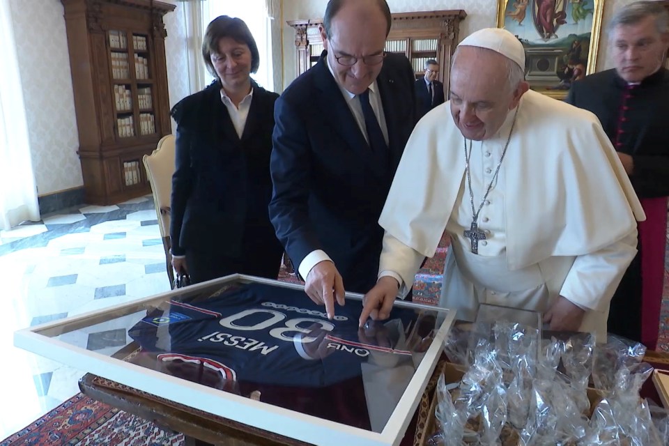 Pope Francis smiles as he receives his special gift