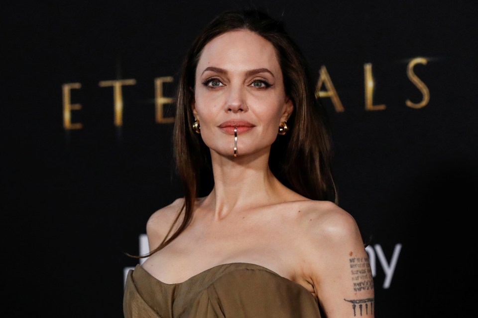 Fans were split over Angelina Jolie's gold chin-cuff but were amazed by her wrinkle-free appearance