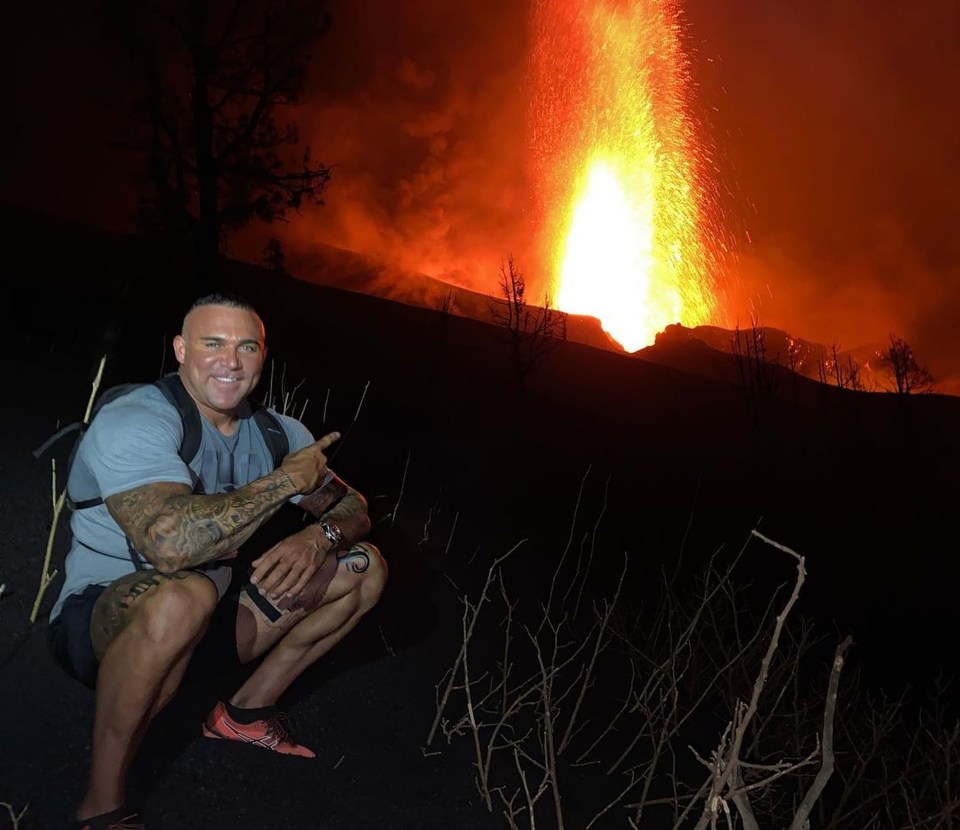 One of the men pointing to to the volcano