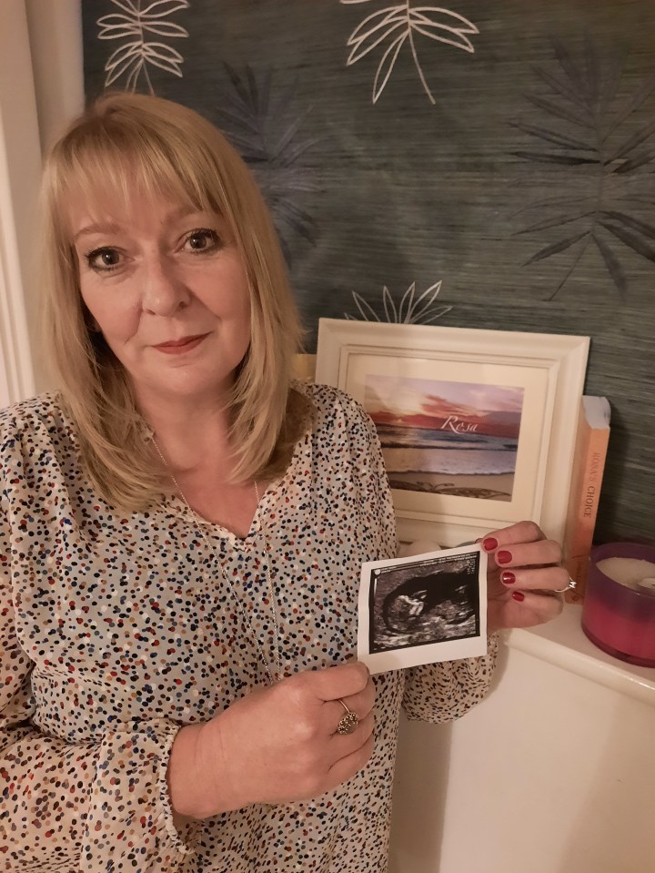 Debra with a scan of her daughter Rosa and a special painting for her.