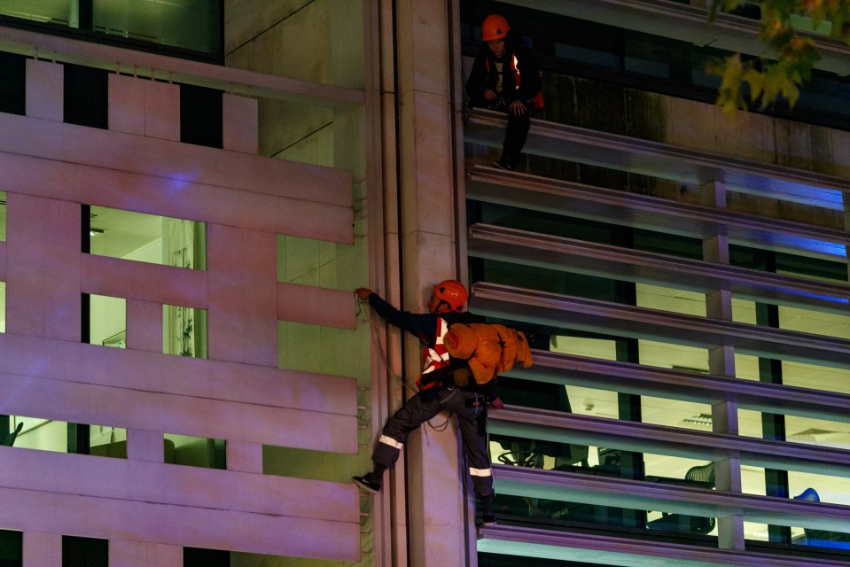 An Animal Rebellion protestor on the side of the DEFRA building