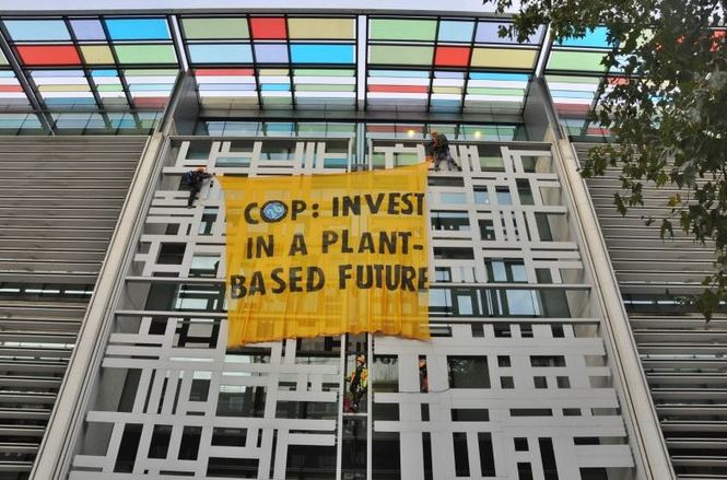 A banner was unfurled from the top of the building reading: 'Invest in a plant-based future'