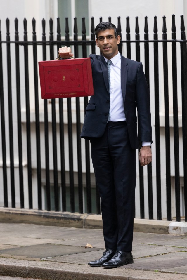 Rishi Sunak holds up his red box with the Budget outside No11 Downing St today