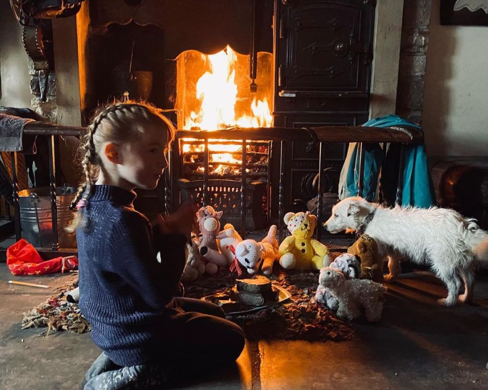 The family have a cosy living room with a fireplace