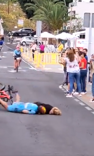 They hit the ground hard with the cyclist's momentum carrying him down the street