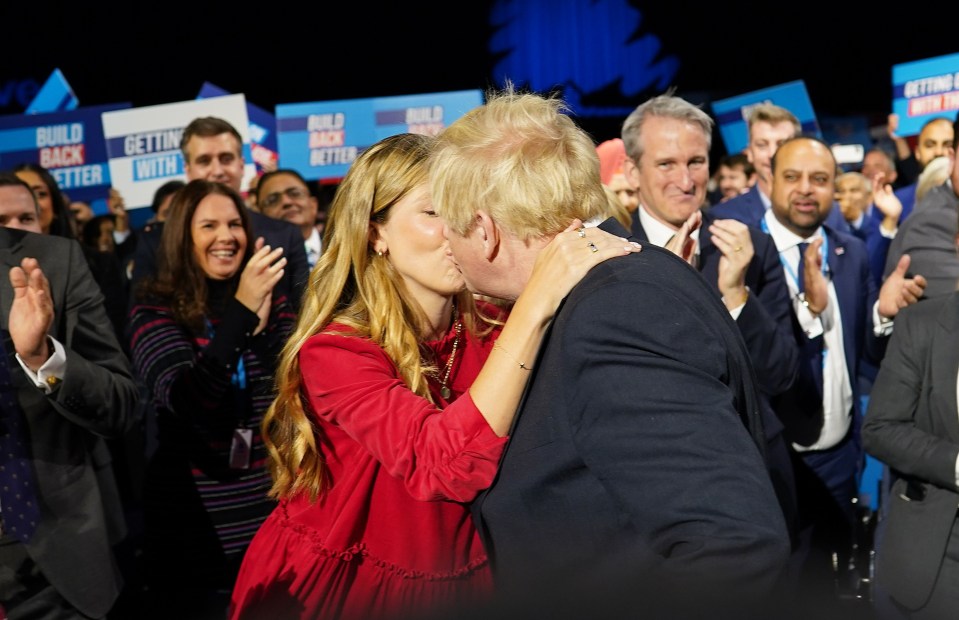 Boris Johnson kisses his wife Carrie in the conference hall