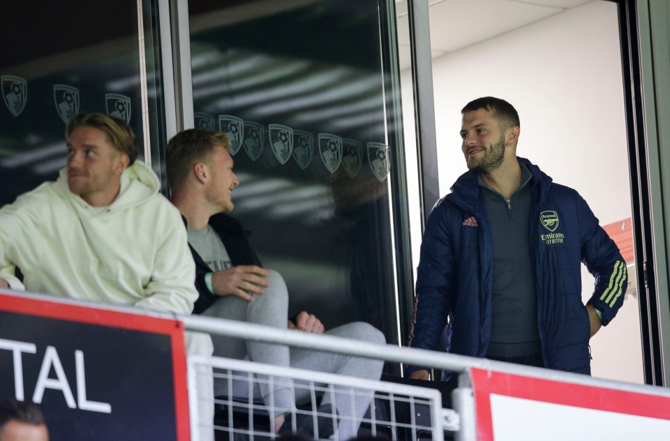 Jack Wilshere sported an Arsenal coat as he watched their Under-23s play Bournemouth