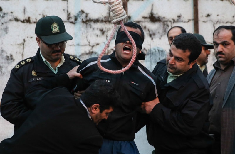 Pictures show a man being led to the gallows by his victim's family in Iran apart of their 'eye for an eye' laws