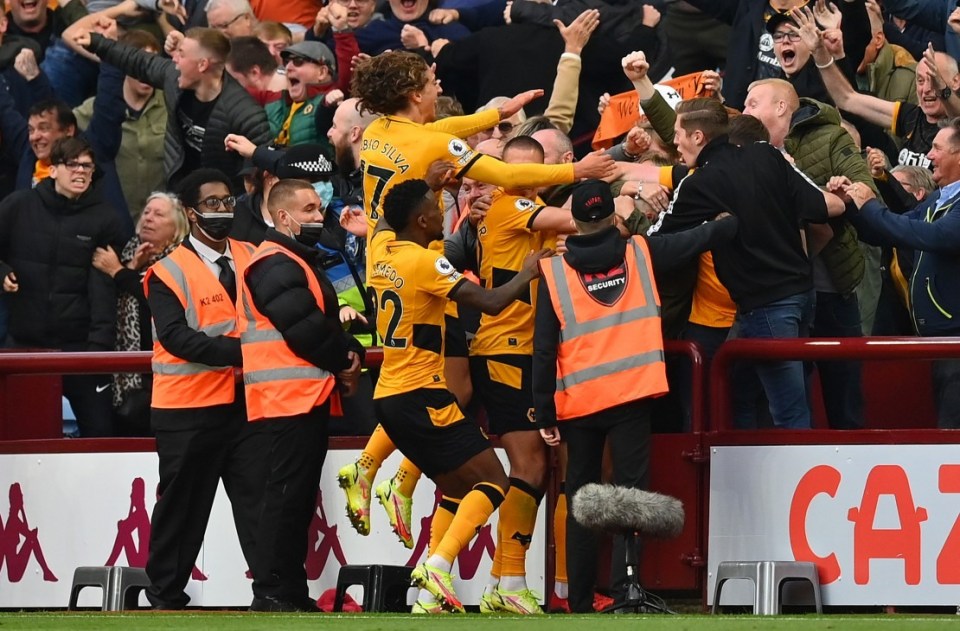 Coady celebrates with fans and his team-mates after scoring the equaliser