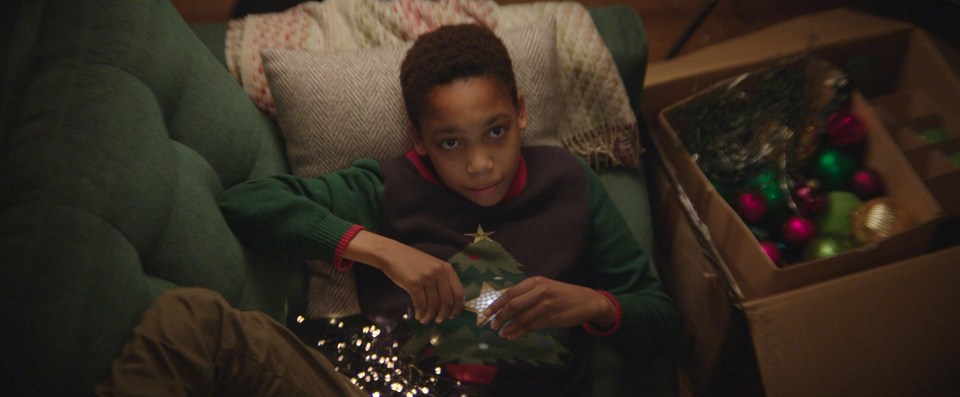 The advert shows Nathan in the Christmas jumper, helping his family with decorations