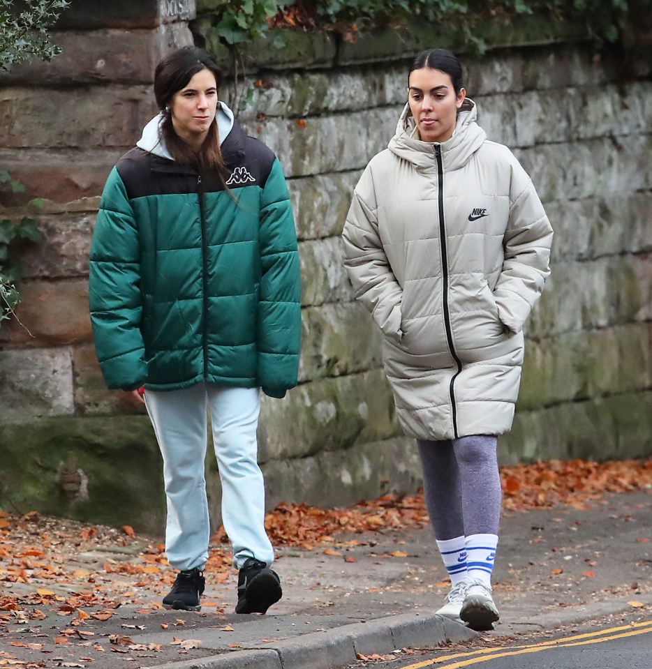 Georgina Rodriguez (right) showed no sign of her baby bump in the long coat