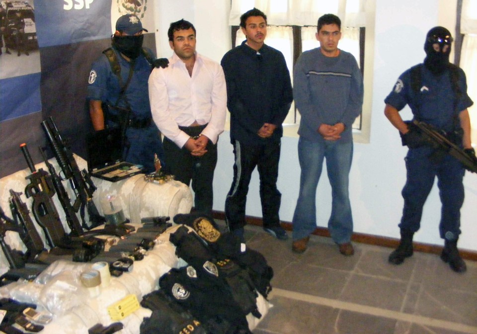 Policemen escort members from the Sinaloa cartel in Mexico City in January 2008, after being arrested during operations against drug trafficking