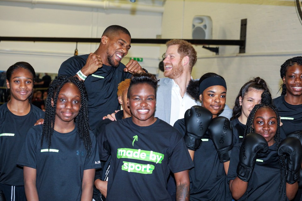 AJ, pictured with Prince Harry, has been hailed for his charity work