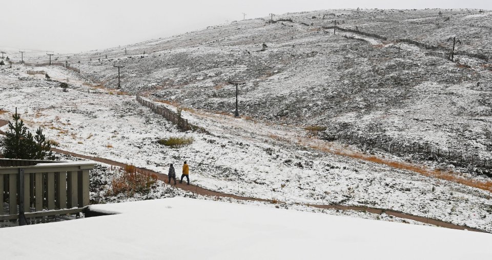 Snow has fallen over the Cairngorms in Scotland, with walkers ankle-deep in the white stuff this morning