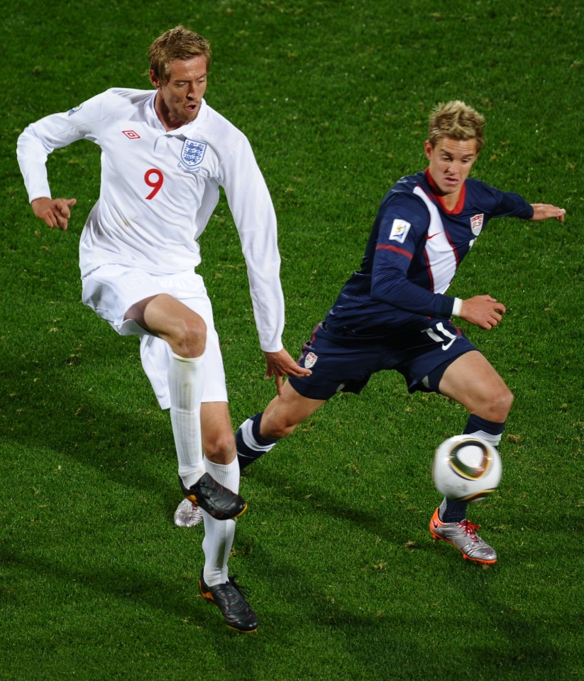 The American challenges England striker Peter Crouch during the 2010 World Cup