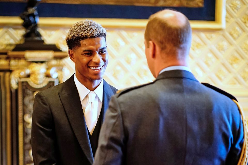 Marcus Rashford smiles as the Duke of Cambridge congratulates him